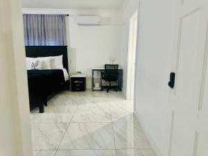 a bedroom with a bed and a television in it at Redhills Escape in Kingston