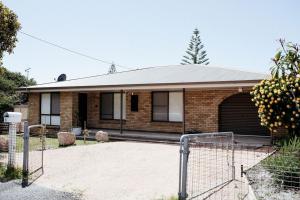 a brick house with a garage at StudioNESS in Scamander