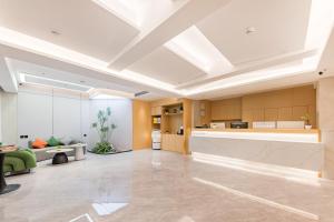 Una gran sala de estar con un gran techo. en Urna Hotel Xiamen Railway Station Lianhua Road Subway Station Branch, en Xiamen