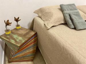 a bed with a side table next to a bed at Casarão Centenário in Passos
