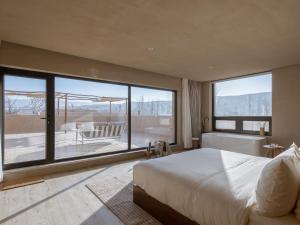 a bedroom with a large bed and a large window at LOSTVILLA(Zhongwei Yellow River Dormitory) in Zhongwei +106 photos