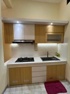 a kitchen with a stove and a sink at Tentrem Madani in Yogyakarta