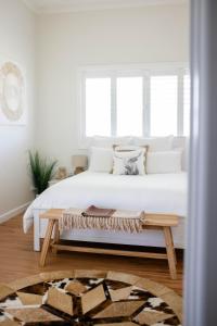 a bedroom with a white bed and a wooden table at Drovers Run B&B and Events Venue 