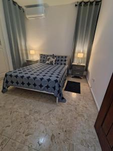 a bedroom with a bed and two night stands at Comfortable and quiet double room in Santo Domingo