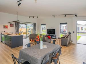 a dining room and living room with a table and chairs at Sun and Sea Sanctuary - Whitianga Holiday Home in Whitianga