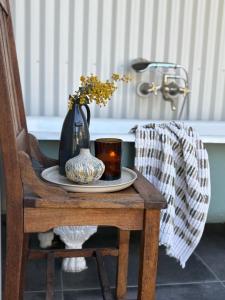 a table with a vase and a plate with a vase at The Pottery Shed in Boambee