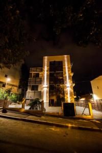 a building with lights in front of it at night at Cluj Business Class in Cluj-Napoca