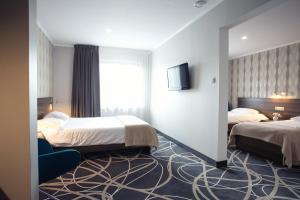 Posteľ alebo postele v izbe v ubytovaní Hotel Nad Nettą