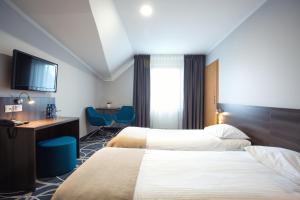 Posteľ alebo postele v izbe v ubytovaní Hotel Nad Nettą