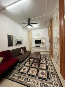 a living room with a couch and a table at HOMESTAY AYER MOLEK Malay ONLY in Air Molek