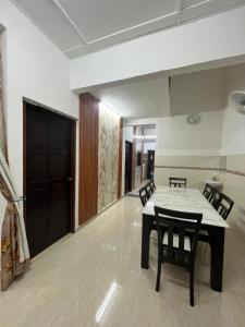 a dining room with a table and chairs at HOMESTAY AYER MOLEK Malay ONLY in Air Molek +4 photos