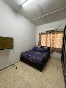 a small bedroom with a bed and a window at HOMESTAY AYER MOLEK Malay ONLY in Air Molek