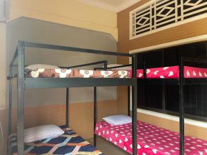 a bunk bed room with two bunk beds in it at The Panda Backpacker Hostel in Kampot