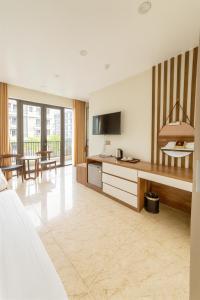 a hotel room with a kitchen and a living room at Square Hostel in Ha Long +43 photos