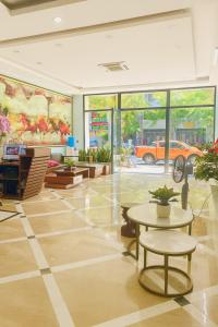 a lobby with a table and a car on the wall at Square Hostel in Ha Long