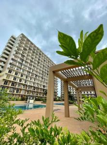 a large apartment building with a pool in front of it at Cel Escapia in Lapu Lapu City