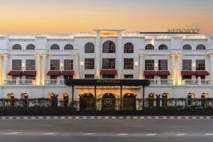 a white building with a sign in front of it at Metropole, Bangkok, a Tribute Portfolio Hotel in Bangkok