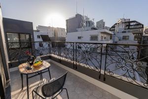 a balcony with a table and chairs on a balcony at Mi-Hotel Kitashinjuku 北新宿 in Tokyo