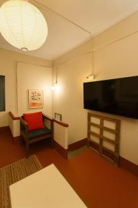 a living room with a large flat screen tv at Classic Jayanagar House for Veg only in Bengaluru