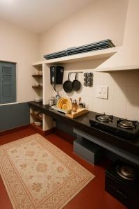 a kitchen with a stove and a counter with pots and pans at Classic Jayanagar House for Veg only in Bengaluru