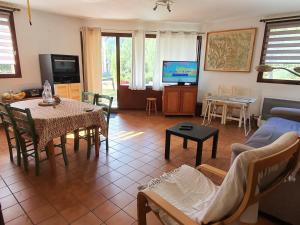 a living room with a table and a couch and a tv at Appartement 6 pers, accès pistes, navette gratuite - FR-1-358-137 in Le Bez