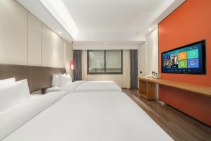 Ένα ή περισσότερα κρεβάτια σε δωμάτιο στο Kaiyuan Mingting Hotel, near Gulou Metro Station, Tianyi Square, Ningbo