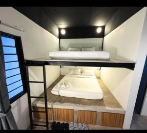 a small room with two beds on a shelf at travellersloft 168 in Johor Bahru