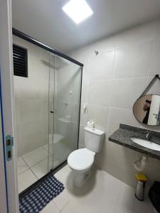 a bathroom with a shower and a toilet and a sink at Apto moderno e aconchegante in Ponta Grossa +16 photos