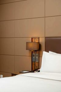 a bedroom with a bed and a lamp next to it at Crowne Plaza Kunming City Centre by IHG in Kunming