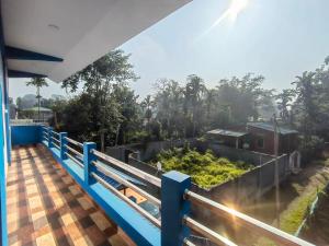 a view from the balcony of a house with a garden at Makum Homestay in Mākum