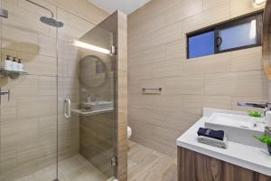 a bathroom with a glass shower and a sink at Playas de Tijuana in Tijuana +45 photos