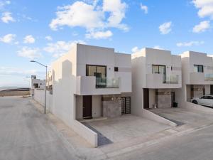 a large white building with a parking lot at Playas de Tijuana in Tijuana