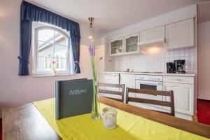 a kitchen with a table with a vase on it at ArtHotel mare in Scharbeutz