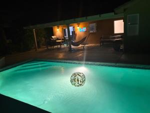 a swimming pool at night with a ball in the water at Desert Vista View in Desert Hot Springs +15 photos