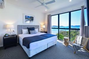 a bedroom with a bed and a large window at Hidden Cove on Hamilton Island by HIHA in Hamilton Island +120 photos
