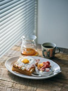 a plate of breakfast food with eggs on a table at Mandarest Hsaa 32 in Ho Chi Minh City +9 photos