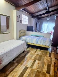 Кровать или кровати в номере Cantinho da Rainha Aparecida do Norte