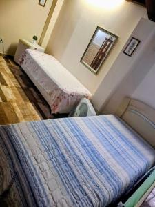 Кровать или кровати в номере Cantinho da Rainha Aparecida do Norte