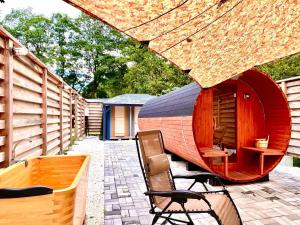 a patio with a circular building with chairs and a table at Our Minano Base - Vacation STAY 92839v in Minano
