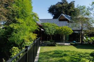 a house with a fence in front of a yard at BaanPranwadee in Ban Na Kai +15 photos