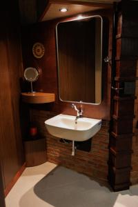 a bathroom with a sink and a mirror at BaanPranwadee in Ban Na Kai