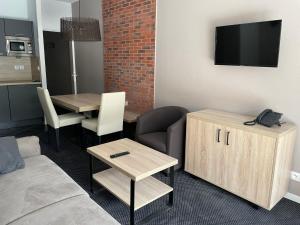 a living room with a couch and a table at Gourette : Studio cosy 4 pers, piscine, animaux acceptés - FR-1-860-58 in Gourette