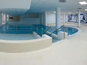 a swimming pool in a hospital room with ailed floor at Gourette : Studio cosy 4 pers, piscine, animaux acceptés - FR-1-860-58 in Gourette