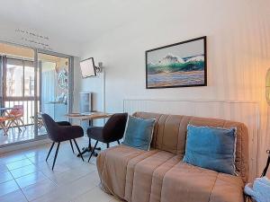 a living room with a couch and a table at Appartement T2 avec Piscine à Vieux-Boucau - FR-1-857-52 in Vieux-Boucau-les-Bains