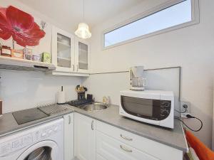 a kitchen with a microwave and a sink at Appartement T2 avec Piscine à Vieux-Boucau - FR-1-857-52 in Vieux-Boucau-les-Bains