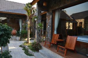 two chairs sitting on the porch of a house at Avana House in Nguyên Ngoại