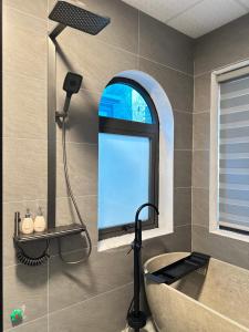 a bathroom with a mirror and a tub and a window at Avana House in Nguyên Ngoại +87 photos
