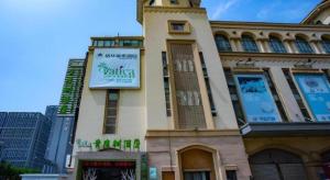 a building with a sign on the side of it at Vatica Lianyungang Haizhou Xinkong South Road Zhongyin Mingdu Hotel in Yuhang