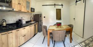 a kitchen with a wooden table and a dining room at Jazmin's Apartments in Oranjestad