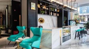 a store with turquoise chairs and a counter in a room at Xana Hotelle·Heyuan Hongxing Road in Heyuan